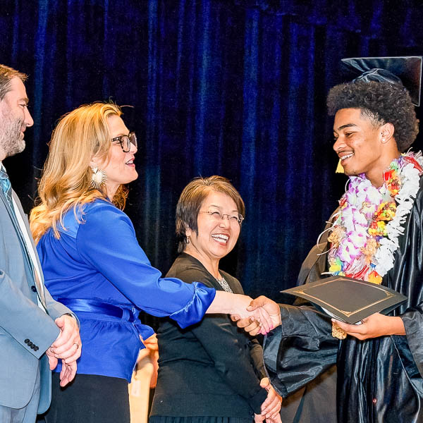 Graduate shaking hands with dignitaries