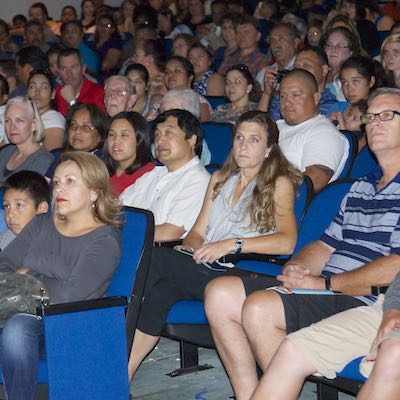 Audience seated in auditorium style chairs