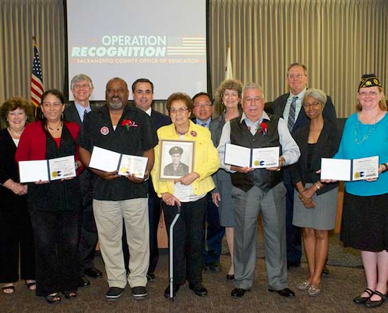 Diploma recipients posing with Board members