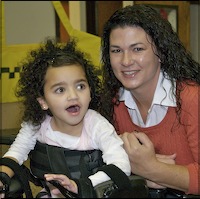 Teacher posing with student using assistive device