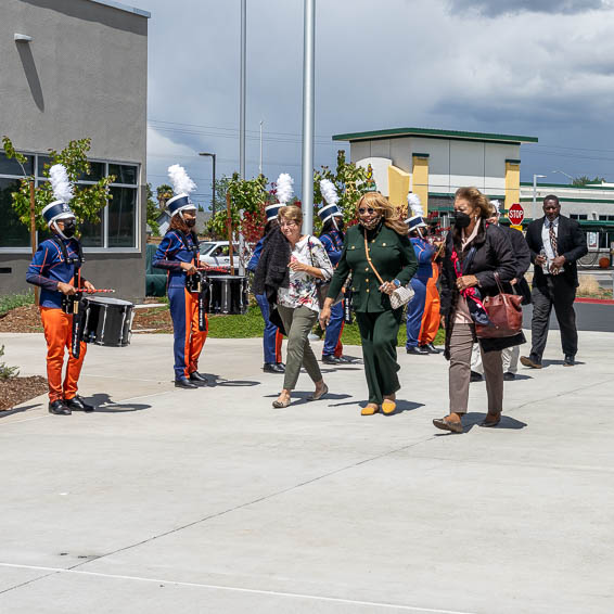 Attendees walking onto campus past the Fortune Charter School Drumline