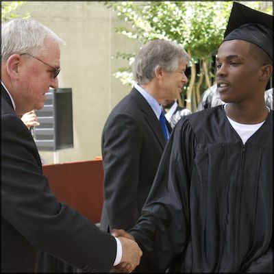 Graduate shaking hands with Dave Gordon