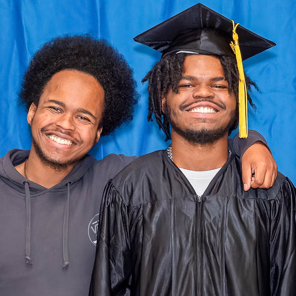 Graduate posing with family member