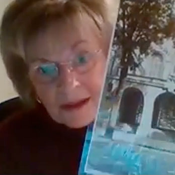 Hanna Krebs holding a photo of her family's synagog