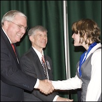 Superintendent shaking hands with student