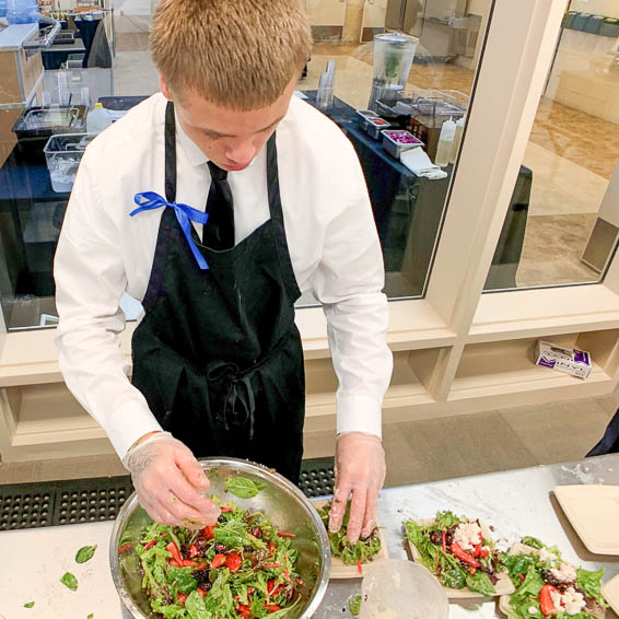 Student preparing salad