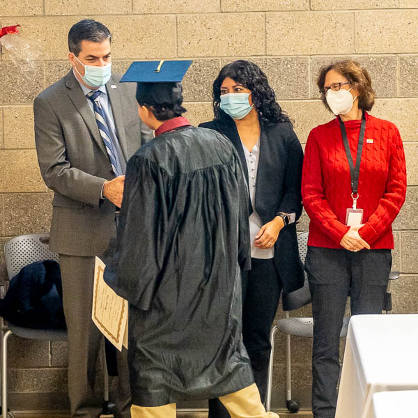 Graduate shaking hands with Board trustees