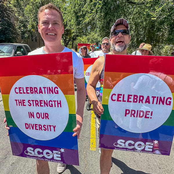 Marchers holding SCOE signs: celebrating the strength in our diversity, celebrating pride