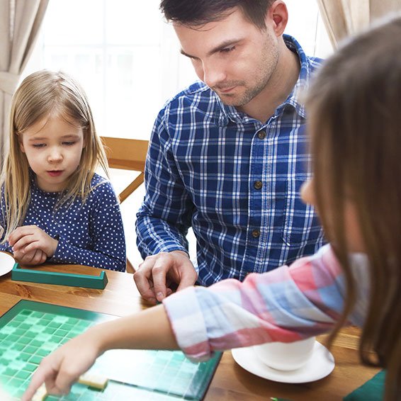 Family playing Scrabble