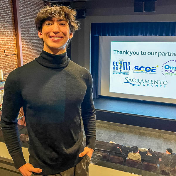 Kyle Santoro posing in front of movie screen