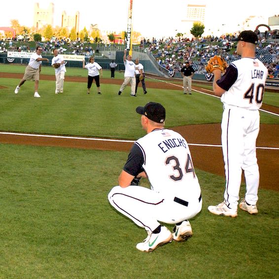 Players watching ceremonial pitches being thrown