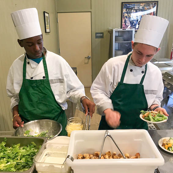 Students making Caesar salad