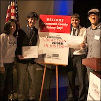 Students with certificates in front of History Day sign