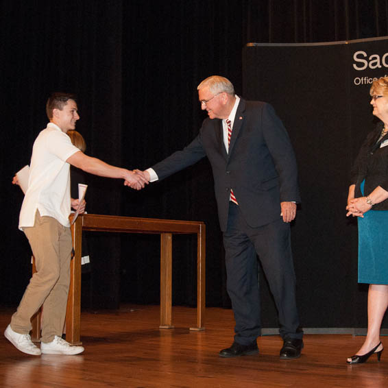 Student shaking hands with superintendent