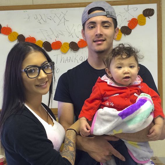 Students holding infant