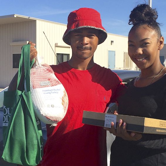 Students holding turkey and pie