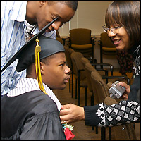 Family helping student get ready for graduation ceremony