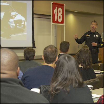 Uniformed officer speaking to audience