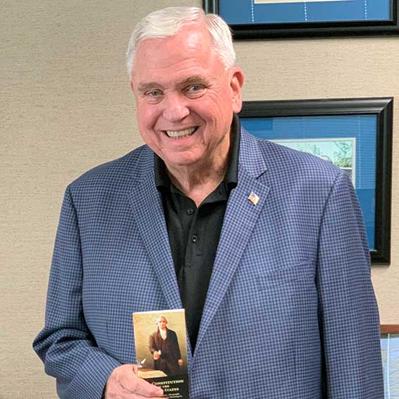 Superintendent holding printed copy of the U.S. Constitution