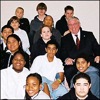 David W. Gordon posing with group of seated students