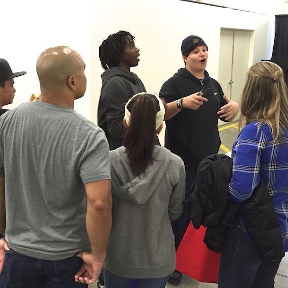 Students talking in front of exhibit