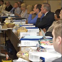 Long row of seated meeting attendees