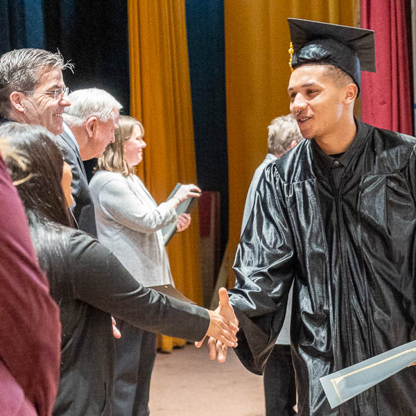 Graduate shaking hands with Mariana Corona Sabeniano