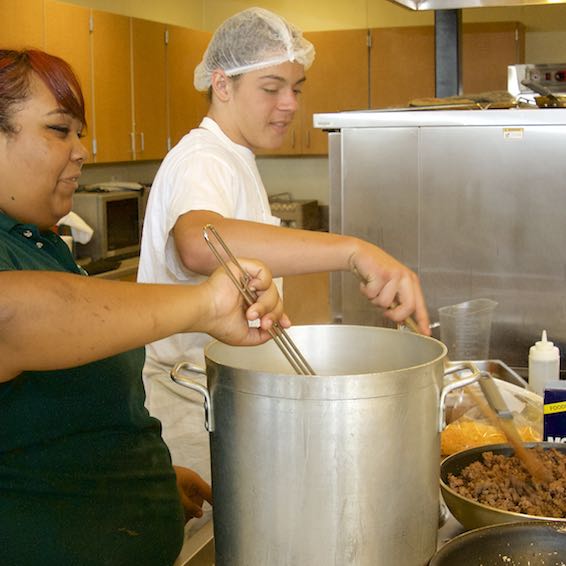 Culinary students stirring and preparing food