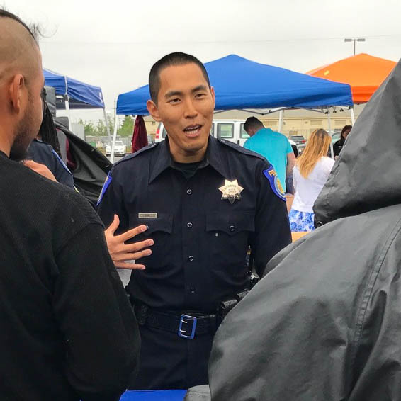 Police officer speaking with clients