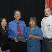 Graduate posing with family