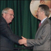 Dave Gordon shaking hands with Henry Wirz