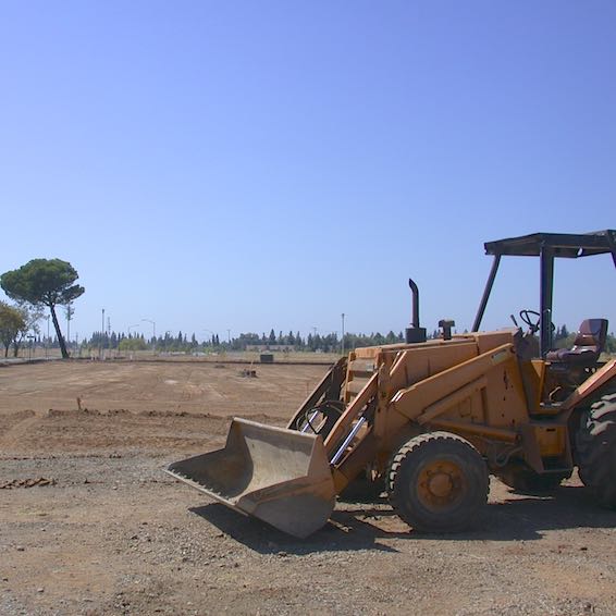 Tractor in front of parking lot under construction