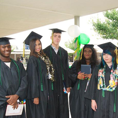 Graduates posing in caps and gowns