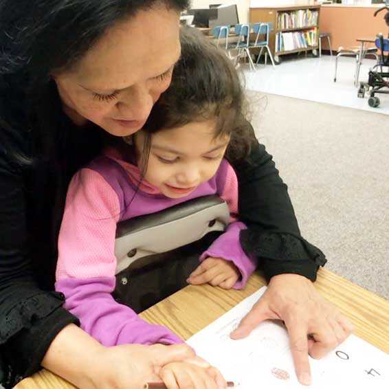 Teacher helping student with schoolwork