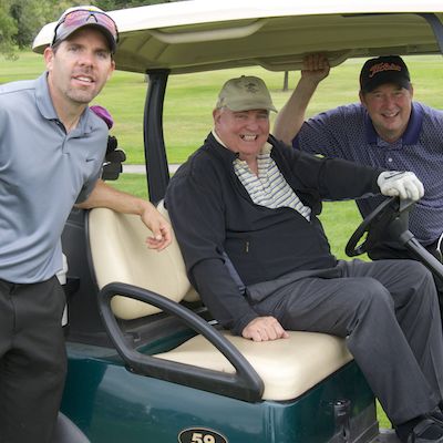 Staff gathered around superintendent in golf cart