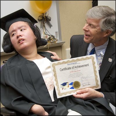 Board member presenting certificate of achievement to student