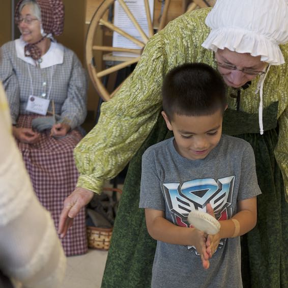 Woman helping student with exhibit