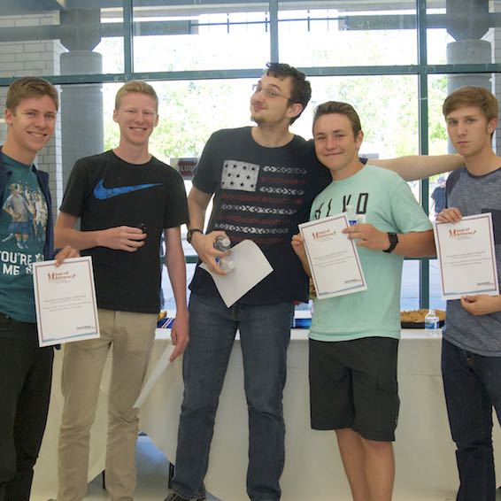 Group of students proudly holding certificates