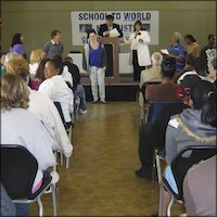 Audience watching students receive awards