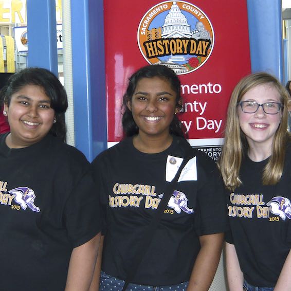 Students posing under History Day sign