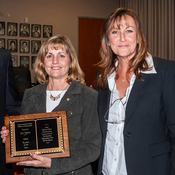 Victoria L. Deane with Jan Valine holding plaque