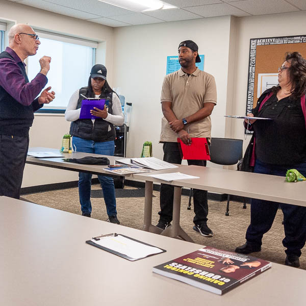 Instructor speaking to visitors
