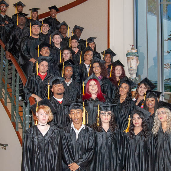 Graduates posing on staircase