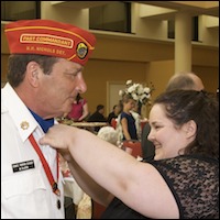 Helping a graduate with his boutonniere 