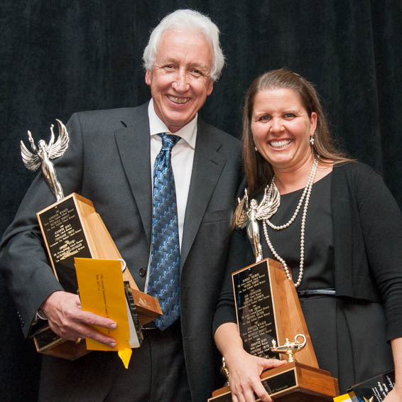 Geroge Helms and Nichole Harshbarger holding plaques and trophies