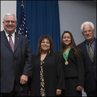 David Gordon poses with scholarship recipient and family