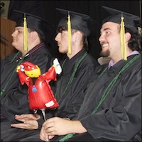 Seated graduates wearing caps and gowns