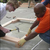 Student hammering wooden frame for planter