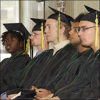 Seated graduates wearing caps and gowns