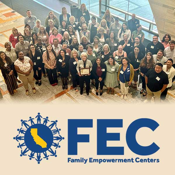 Large group posing in lobby with FEC logo superimposed